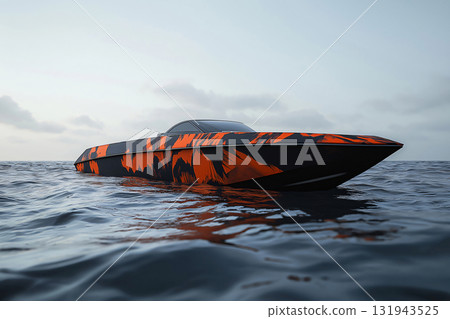 Modern speedboat with striking orange and black wrap design, floating serenely on calm water under a soft sky 131943525