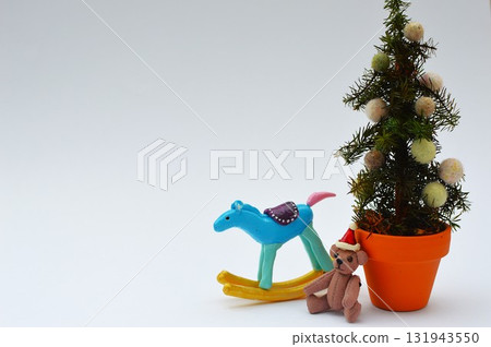 Small Christmas tree, teddy bear and rocking horse 131943550