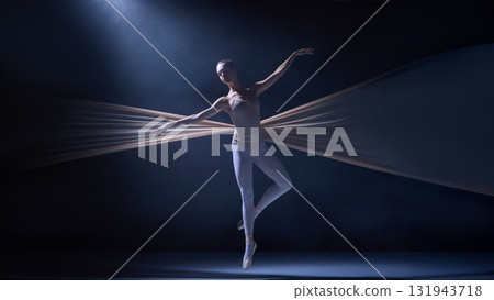 Ballet dancer poised midair entangled in fabric wings illuminated by soft light 131943718
