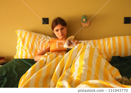 A peaceful lifestyle image of a woman female reading a book in h A peaceful lifestyle image of a woman female reading a book in h 131943770