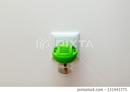 an electric fumigator or insecticide repellent device plugged into a socket. protect indoor spaces from mosquitoes and pests, is a clean, green object against a complementary white background an electric fumigator or insecticide repellent device plugged into a socket. protect indoor spaces from mosquitoes and pests, is a clean, green object against a complementary white background 131943775