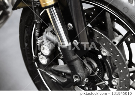 Detailed close-up photo of a motorcycle front wheel with disc brake 131945010