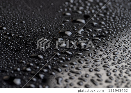 Black glass surface with white spots in water droplets close up, wet mirrored black glass in a large number of water droplets Black glass surface with white spots in water droplets close up, wet mirrored black glass in a large number of water droplets 131945462