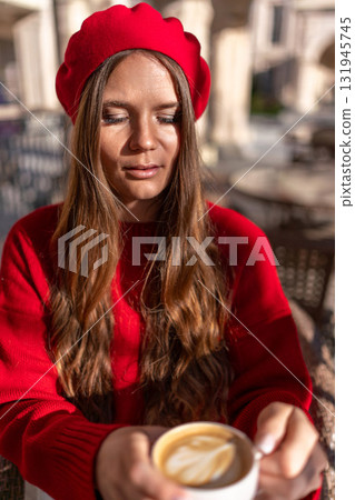 Woman beret coffee: Girl in red enjoys latte outside cafe during day, casually relaxing. Woman beret coffee: Girl in red enjoys latte outside cafe during day, casually relaxing. 131945745