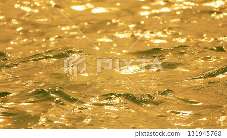Water, Sunlight, Reflections - Close-up of shimmering water reflecting golden light. Water, Sunlight, Reflections - Close-up of shimmering water reflecting golden light. 131945768