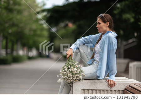 Woman Flowers Park: Pensive woman with daisies relaxes in park, summer day, enjoying the beauty of nature. Woman Flowers Park: Pensive woman with daisies relaxes in park, summer day, enjoying the beauty of nature. 131945790