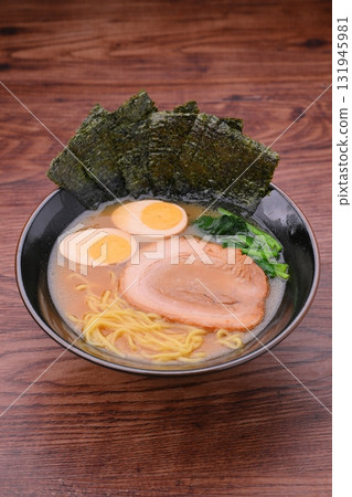 Pork bone soy sauce ramen, rich ramen, topped with thick-cut pork, boiled egg, and spinach. Pork bone soy sauce ramen, rich ramen, topped with thick-cut pork, boiled egg, and spinach. 131945981