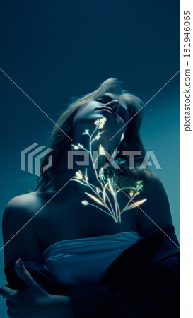 Woman with glowing botanical light projection on neck and shoulder in blue light Woman with glowing botanical light projection on neck and shoulder in blue light 131946065