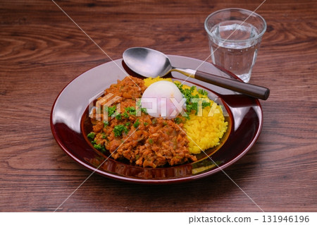 Homemade dry curry with minced beef and pork, onions and peppers (turmeric rice) 131946196