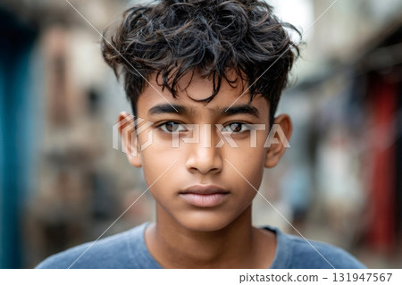 Young boy looking at camera with serious expression 131947567