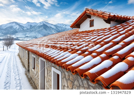 Rustic house roof with snow and mountains 131947829