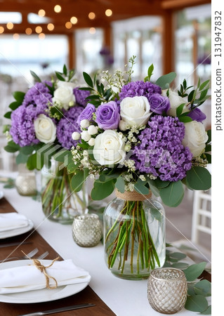 Wedding reception table decorating with purple and white flower centerpieces 131947832