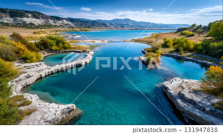 Geothermal hot springs flowing into turquoise lake water 131947838