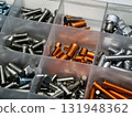 Variety of fasteners organized in clear storage container for easy access and identification 131948362