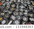 Variety of mechanical components organized in clear containers on a black surface for easy identification and access 131948363