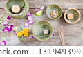 Loy Krathong flat lay with flowers and candle on wooden background 131949399