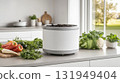 Indoor compost setup with fresh vegetables and herbs on kitchen counter 131949404