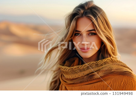 Blonde influencer posing in desert wearing ethnic shawl 131949498