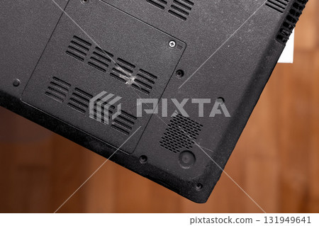 Back side of old black laptop on table close up. Top view 131949641