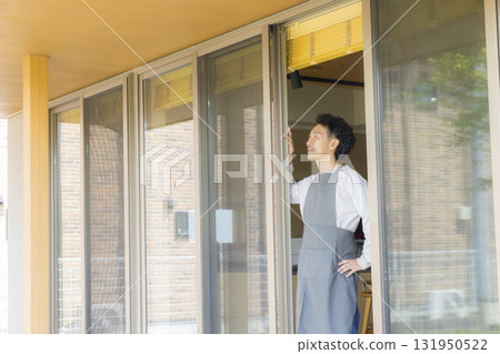 A man opening a window 131950522