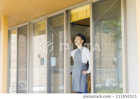A man opening a window 131950523