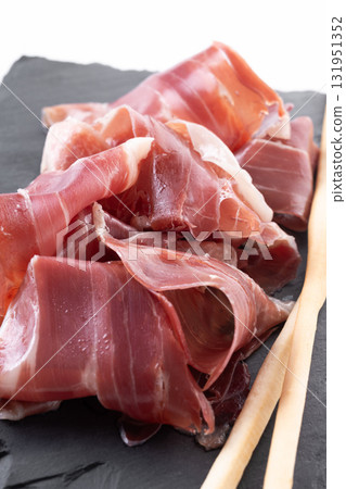 Slices of Spanish Serrano Ham isolated on white background 131951352