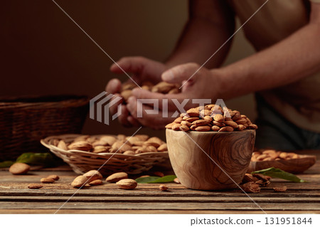Almond nuts on an old wooden table. 131951844