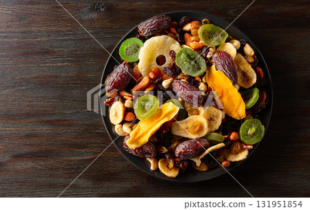 Dried tropical fruits with various nuts and raisins. Dried tropical fruits with various nuts and raisins. 131951854