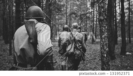 Black-and-White Soldiers Marching Through Dense Forest 131952371