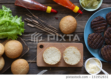 Burger ingredients on rustic wooden table Burger ingredients on rustic wooden table 131952631