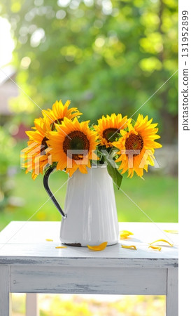 A beautiful yellow sunflower bouquet in a glass vase is a vibrant summer nature arrangement 131952899