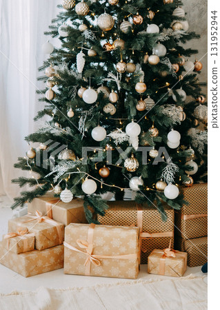 Decorated Christmas tree with shiny lights and ornaments. Festive holiday interior for greeting card design or seasonal advertisement. New Year mood. Decorated Christmas tree with shiny lights and ornaments. Festive holiday interior for greeting card design or seasonal advertisement. New Year mood. 131952944