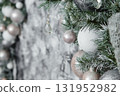 Close-up of a decorated Christmas tree with silver and white ornaments and crystal drops. Holiday interior decoration for a festive ambiance. 131952982