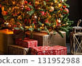 Christmas tree decorated with festive ornaments and glowing lights, with holiday presents on the floor. Winter celebration and seasonal decor concept. 131952988