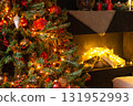 Close up of a decorated Christmas tree with glowing lights, red berries, and pine cones. Holiday season celebration concept for winter. 131952993