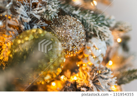 Merry Christmas Xmas happy holidays. Golden silver ornament decoration ball, defocused garland lights on classic decorated Christmas tree. Christmas tree with frosty ornaments. Christmas eve at home Merry Christmas Xmas happy holidays. Golden silver ornament decoration ball, defocused garland lights on classic decorated Christmas tree. Christmas tree with frosty ornaments. Christmas eve at home 131954355
