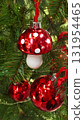 Christmas tree branches with a red Fly agaric toy as decoration 131954465