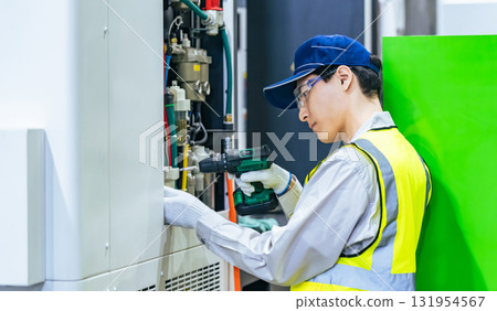 一名工人在工廠維護工具機 一名工人在工廠維護工具機 131954567