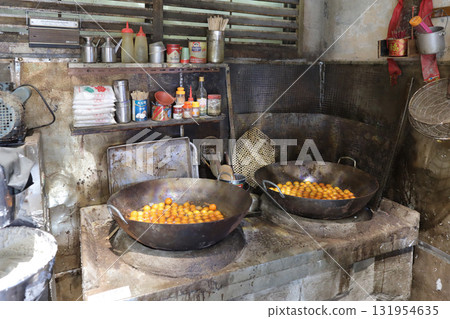 Rustic Basket Of Small Orange Fruits On Wooden Table Beside Rustic Basket Of Small Orange Fruits On Wooden Table Beside 131954635