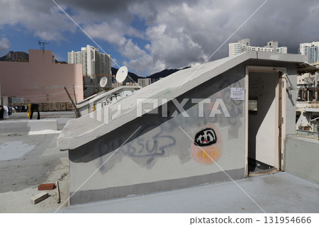 Rooftop Scene With Graffiti, Stairway, and City Skyline 131954666