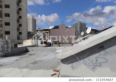 Rooftop Scene With Graffiti, Stairway, and City Skyline Rooftop Scene With Graffiti, Stairway, and City Skyline 131954667