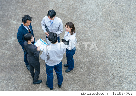 Group of office workers gathered outdoors to talk 131954762