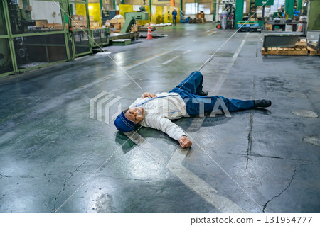 Worker collapses on factory floor Worker collapses on factory floor 131954777