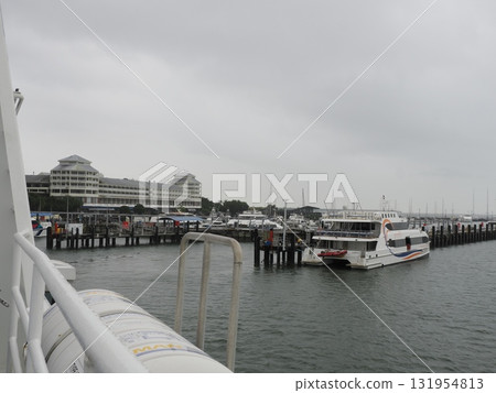 Cairns Port – a cloudy day transport hub lined with ships and buildings Cairns Port – a cloudy day transport hub lined with ships and buildings 131954813