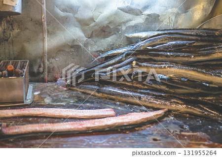 Sept 27 2025 Stacked Eels In A Cold Market Kitchen With Wet Surfaces Sept 27 2025 Stacked Eels In A Cold Market Kitchen With Wet Surfaces 131955264