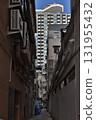 Sept 27 2025 Narrow Urban Alley Between Buildings With Industrial Pipes 131955432