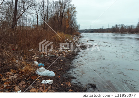 Riverbank covered in garbage and industrial runoff, highlighting the environmental damage caused by pollution Riverbank covered in garbage and industrial runoff, highlighting the environmental damage caused by pollution 131956077