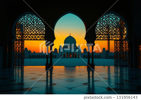 Mosque is bathed in the golden light of sunset, reflecting on the polished floor through ornate arches 131956143