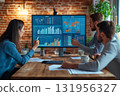 Business professionals having a productive meeting, analyzing financial data displayed on a large digital screen 131956327