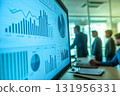 Team of business professionals is working together, analyzing financial data displayed on a computer screen 131956331